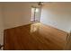 Cozy bedroom featuring hardwood floors, neutral paint and access to balcony at 1725 Pine Ridge E Way # C, Palm Harbor, FL 34684