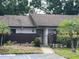 Charming one-story condo with a well-maintained front yard and covered entrance at 1725 Pine Ridge E Way # C, Palm Harbor, FL 34684