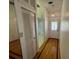 Inviting hallway with hardwood floors and closet space at 1725 Pine Ridge E Way # C, Palm Harbor, FL 34684
