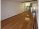 Bright living room featuring hardwood floors and a wall mirror enhancing the sense of space at 1725 Pine Ridge E Way # C, Palm Harbor, FL 34684