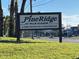Entrance sign for Pine Ridge at Palm Harbor, a deed-restricted condominium community at 1725 Pine Ridge E Way # C, Palm Harbor, FL 34684
