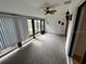 Bright sunroom with ceiling fan, neutral carpet and large windows offering natural light at 1725 Pine Ridge E Way # C, Palm Harbor, FL 34684