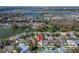 Stunning aerial view of a waterfront home and lush community with lake views and mature landscaping at 1728 Elk Spring Dr, Brandon, FL 33511