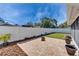 Landscaped backyard showcasing a pristine white fence and a meticulously designed patio area at 1728 Elk Spring Dr, Brandon, FL 33511
