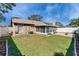 Backyard featuring a screened-in porch, expansive lawn, and brick-paved patio at 1728 Elk Spring Dr, Brandon, FL 33511