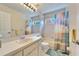 Bathroom featuring a white-tiled tub/shower combo, single sink, and a large mirror at 1728 Elk Spring Dr, Brandon, FL 33511