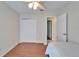 Bedroom featuring wood-look floors, closet with sliding doors, and ceiling fan with lighting at 1728 Elk Spring Dr, Brandon, FL 33511