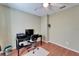 This bedroom has wood-look floors, a ceiling fan, and a desk area with printer at 1728 Elk Spring Dr, Brandon, FL 33511