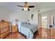 This bedroom has wood floors, ceiling fan and a view to the attached bathroom at 1728 Elk Spring Dr, Brandon, FL 33511