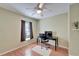 Cozy bedroom featuring a ceiling fan, window with blinds, and a work desk area at 1728 Elk Spring Dr, Brandon, FL 33511