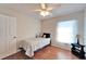 Bedroom with hardwood floors, ceiling fan, natural light, and simple decor at 1728 Elk Spring Dr, Brandon, FL 33511