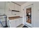 Organized garage featuring cabinets, countertop, and convenient access to outside at 1728 Elk Spring Dr, Brandon, FL 33511