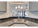 Stylish kitchen sink with dual basins and black granite countertop, seamlessly connecting to the living area at 1728 Elk Spring Dr, Brandon, FL 33511