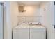 This is a view of the in-unit laundry area with a white washer and dryer at 1728 Elk Spring Dr, Brandon, FL 33511