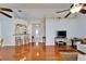 Open living room boasts vaulted ceilings, wood floors, and seamless flow to kitchen and front entry at 1728 Elk Spring Dr, Brandon, FL 33511
