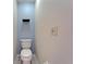 This half-bath features a white toilet, tiled floors and light blue paint at 1728 Elk Spring Dr, Brandon, FL 33511