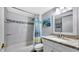 This bathroom features a white sink and cabinets, a shower, and granite countertops at 2 Adalia Ave # 803, Tampa, FL 33606
