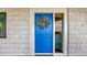 Charming blue front door with a decorative wreath and welcome mat at 2 Adalia Ave # 803, Tampa, FL 33606