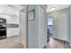 Hallway with tile floors leading to the kitchen and a bright entryway with a blue accent table at 2 Adalia Ave # 803, Tampa, FL 33606