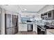 Modern kitchen featuring stainless steel appliances, granite countertops, and sleek white cabinets at 2 Adalia Ave # 803, Tampa, FL 33606