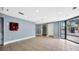 Bright condo lobby featuring neutral tile flooring, stainless steel elevator, and large impact glass window at 2 Adalia Ave # 803, Tampa, FL 33606