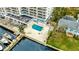 Relaxing community pool with lounge seating, mature palm, and waterfront location at 2 Adalia Ave # 803, Tampa, FL 33606