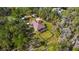 Aerial view of sprawling home on wooded lot with fenced yard, large deck for outdoor living, and mature trees at 22259 Skyview Cir, Brooksville, FL 34602