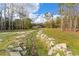 The creek runs into a beautiful backyard with a house in the distance at 22259 Skyview Cir, Brooksville, FL 34602