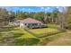 Beautifully maintained backyard with an expansive lawn, wood deck, and dark metal fence at 22259 Skyview Cir, Brooksville, FL 34602