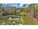 Scenic view of the backyard featuring a tranquil stream surrounded by mature trees at 22259 Skyview Cir, Brooksville, FL 34602