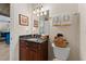 Bathroom featuring granite countertop vanity, decorative towels and framed mirror at 22259 Skyview Cir, Brooksville, FL 34602