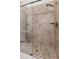 Shower with glass door and neutral tile at 22259 Skyview Cir, Brooksville, FL 34602