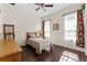 Cozy bedroom with wood floors, natural light and decorative window treatments at 22259 Skyview Cir, Brooksville, FL 34602