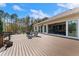 The back deck features outdoor furniture with a view of the home's sliding glass doors and a lush green lawn at 22259 Skyview Cir, Brooksville, FL 34602