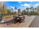Expansive outdoor deck with dining and seating areas, perfect for entertaining and enjoying the surrounding landscape at 22259 Skyview Cir, Brooksville, FL 34602