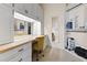 Bright dressing room with custom cabinets, makeup vanity with mirror, and convenient wardrobe racks for organized storage at 22259 Skyview Cir, Brooksville, FL 34602