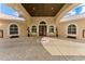 Grand entrance featuring double doors, arched windows, symmetrical landscaping, and covered entry with ceiling detail at 22259 Skyview Cir, Brooksville, FL 34602