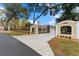 Exterior view of a gated estate featuring a long driveway leading to the home with mature trees and landscaping at 22259 Skyview Cir, Brooksville, FL 34602