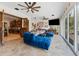 Stylish living space featuring blue upholstered furniture, tile flooring, large windows, and an open layout at 22259 Skyview Cir, Brooksville, FL 34602