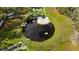 Aerial view of a picturesque pond with a dock and lush greenery at 22259 Skyview Cir, Brooksville, FL 34602