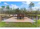 Outdoor wood deck with furniture overlooking the peaceful pond with wildlife at 22259 Skyview Cir, Brooksville, FL 34602