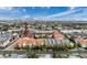 Aerial view of condo community with manicured lawns, colorful roofs, and a city skyline view at 2410 W Azeele St # 220, Tampa, FL 33609