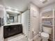 Well-lit bathroom with dark vanity, modern fixtures, and organized storage at 2410 W Azeele St # 220, Tampa, FL 33609