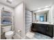 Bathroom featuring a toilet, a shelf tower, a dark vanity and a large mirror at 2410 W Azeele St # 220, Tampa, FL 33609
