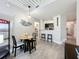 Charming dining area with a round table, sleek chairs, and a view into the kitchen at 2410 W Azeele St # 220, Tampa, FL 33609