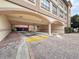 Building entrance featuring covered parking and brick-paved drive at 2410 W Azeele St # 220, Tampa, FL 33609