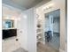 Hallway leading to bathroom, kitchen, and showcasing convenient storage at 2410 W Azeele St # 220, Tampa, FL 33609
