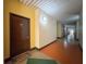 View of the colorful hallway leading to unit 220, complete with bright lighting and welcome mat at 2410 W Azeele St # 220, Tampa, FL 33609