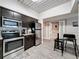 Open kitchen with stainless steel appliances, breakfast bar, and easy access to adjacent dining area at 2410 W Azeele St # 220, Tampa, FL 33609