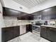 Modern kitchen featuring stainless steel appliances, granite countertops, and ample cabinet space at 2410 W Azeele St # 220, Tampa, FL 33609